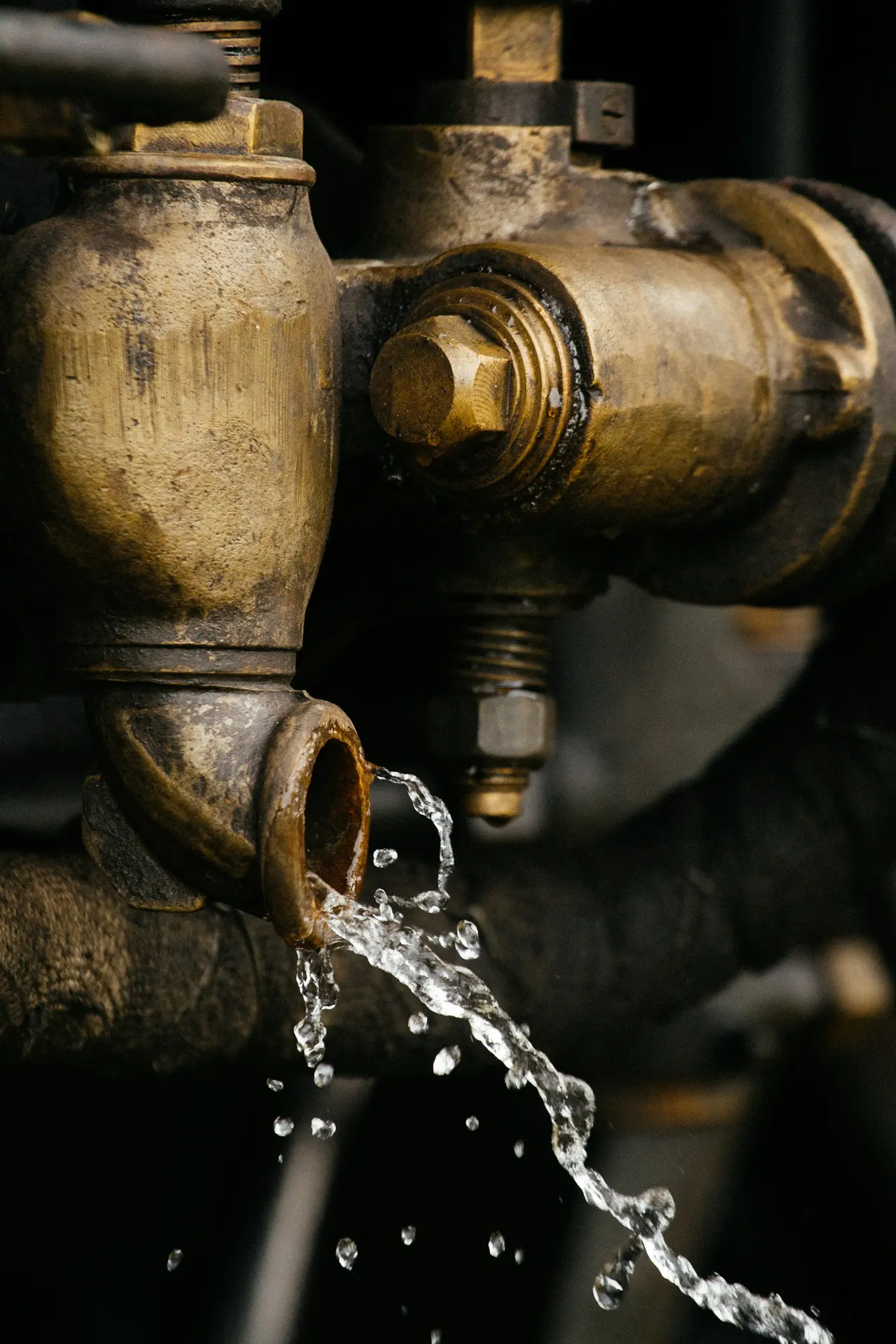 Water running from an old brass pipe fitting